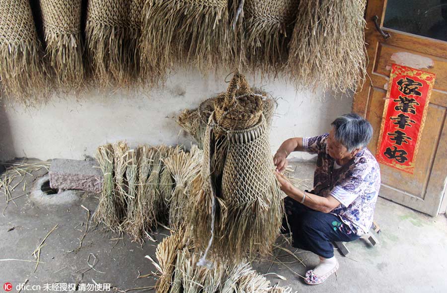 Woman keeps art of making straw rain cape alive