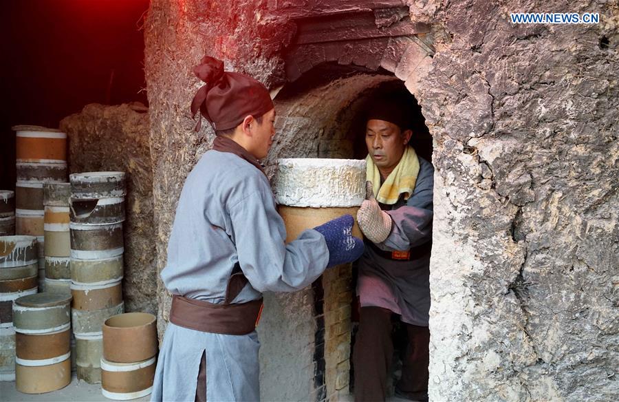 Ceremony taking porcelains out of kiln held in central China