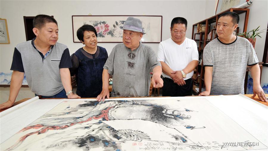 Artist demonstrates finger paintings