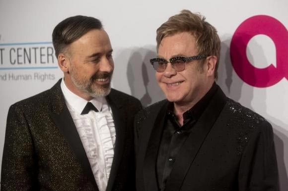 Gay British musician Elton John marries partner under new law