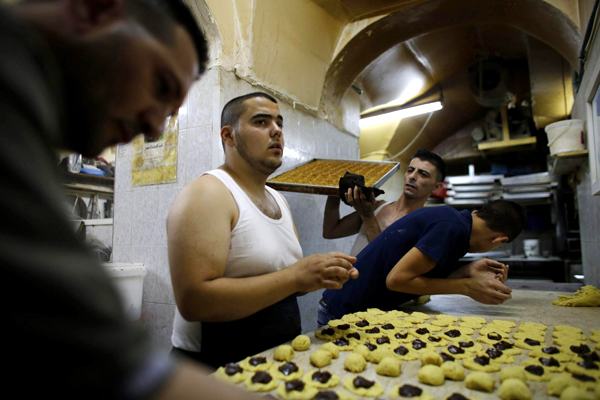 Workers prepare traditional cookies for Eid al-Fitr