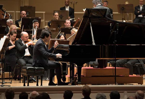 Chinese pianist Lang Lang performs music during the shooting of