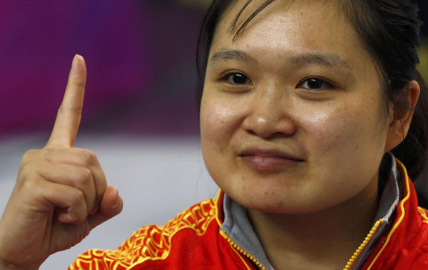 China&#39;s Guo Wenjun celebrates after winning the women&#39;s 10m Air Pistol finals competition at the London 2012 Olympic Games in the Royal Artillery Barracks ... - 0023ae696209117f6e8831