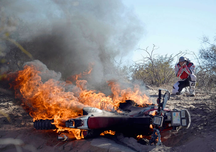 Paulo Goncalves' bike in flames in the Dakar Rally