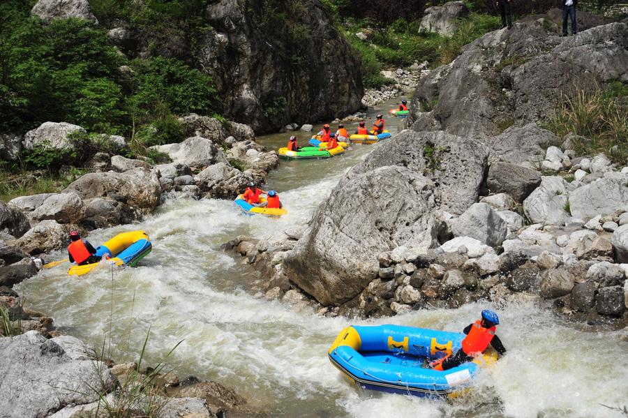 Tourists drift by rafts at China's Chaotianhou scenery spot