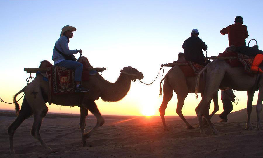 Tourists visit Mingsha Mountain in Dunhuang, NW China