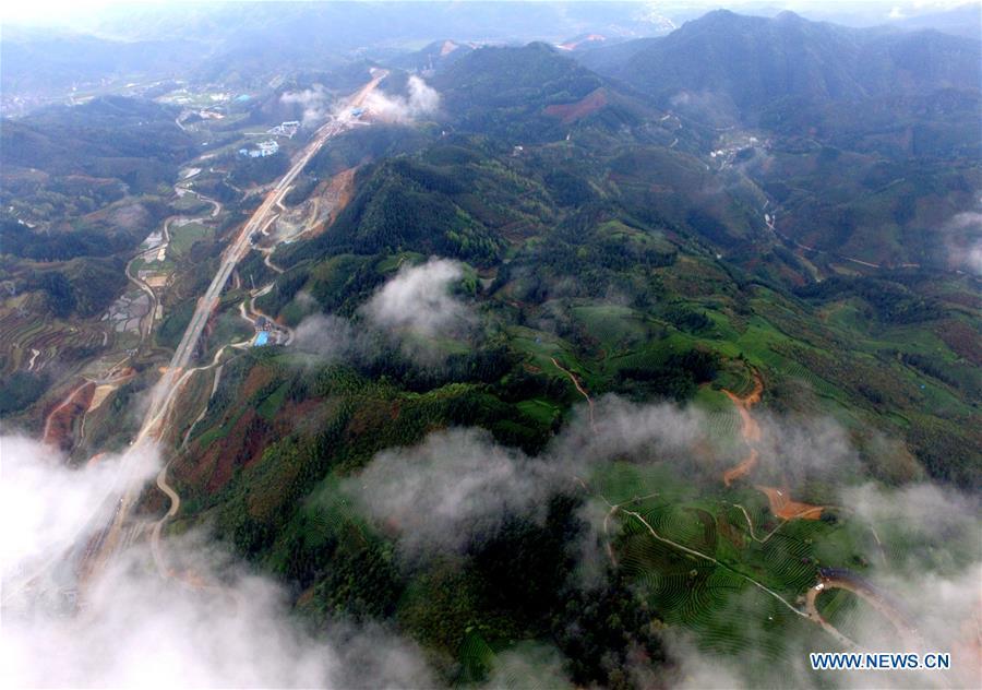 Aerial photos show green landscape covered by clouds in S China
