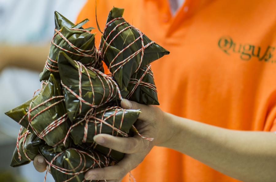 Workers in Central China make zongzi before Dragon Boat Festival