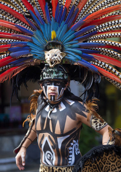 A Mexican man wearing a costume performs at a tourist area of Playa del Carmen in Mexico. Pedro Pardo / Agence France-Presse Once-thriving Mayas struggle for survival