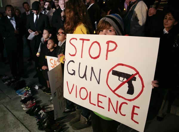 Obama promises gun control action next year