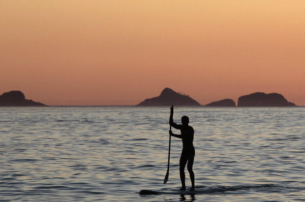 Surfer takes to the water in Rio de Janeiro