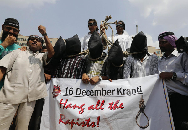 Demonstrators with their heads covered by black cloth take part in a protest outside a court in New Delhi September 10, 2013. Four men were found guilty on Tuesday of the gang rape and murder of a 23-year-old woman in New Delhi last year, according to a defence lawyer in a case that sparked global outrage and protests in India over the lack of safety for women in the world's largest democracy. 1 in 4 men in parts of Asia have raped