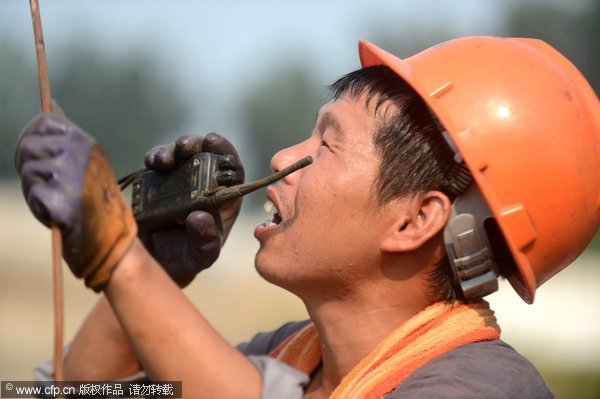 Workers cope with sweltering heat in Jiangsu province