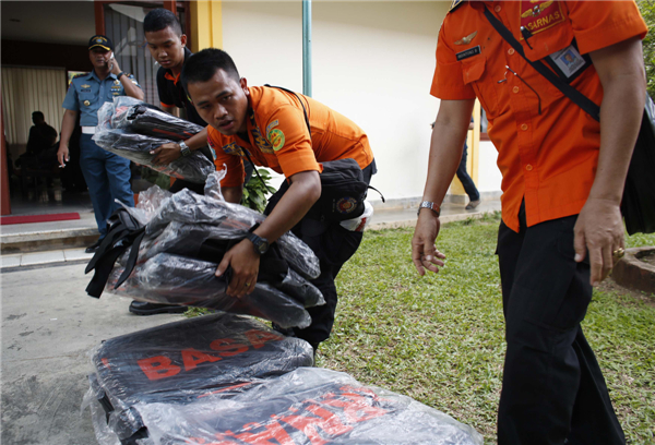 Bodies, debris from missing AirAsia plane pulled from sea off Indonesia