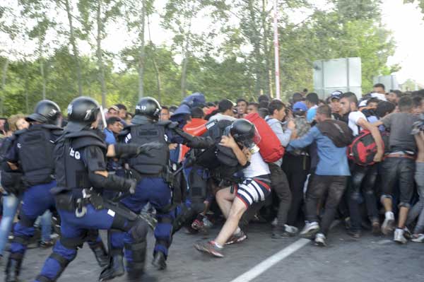 Hungarian riot police detain migrants