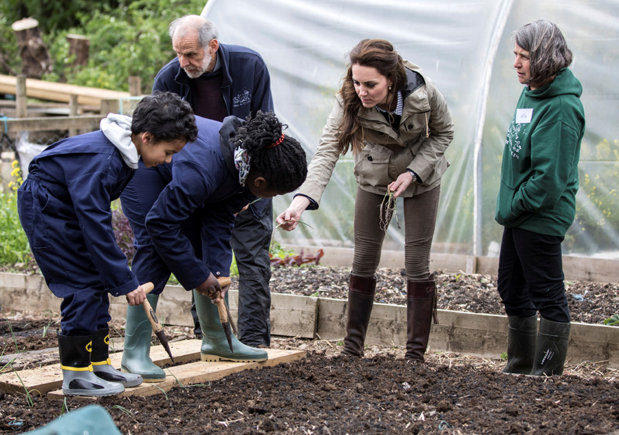 UK's Duchess Catherine joins school children down on the farm