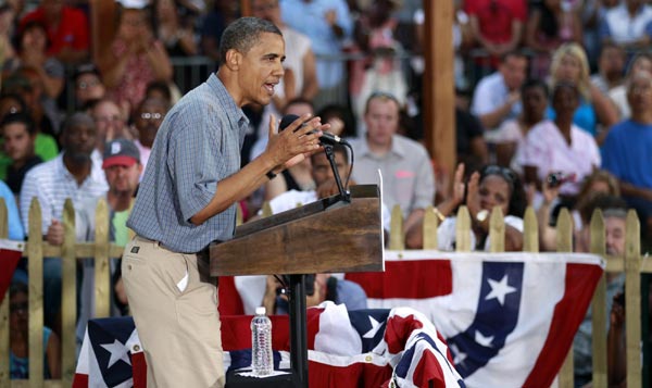 Obama touts record, attacks Romney on campaign bus tour