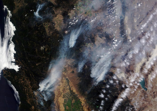 California declares emergency as wildfire advances on town