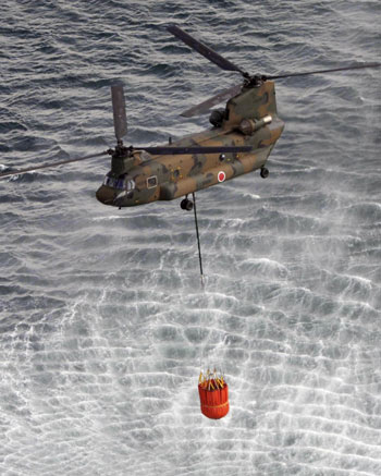 Japanese choppers dump water on stricken reactor