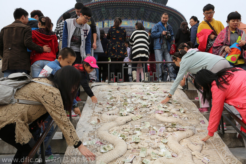 Visitors trade cash for luck at World Heritage site