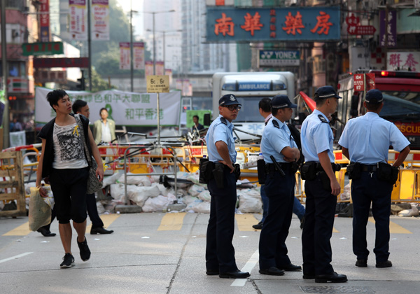 HK police vow minimum force to remove protest road barriers