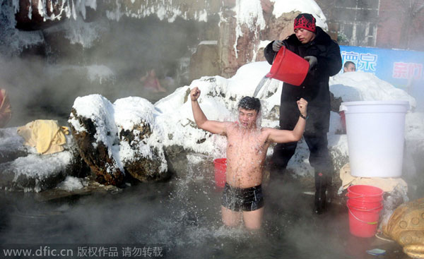 Girls in bikini pour ice in hot spring