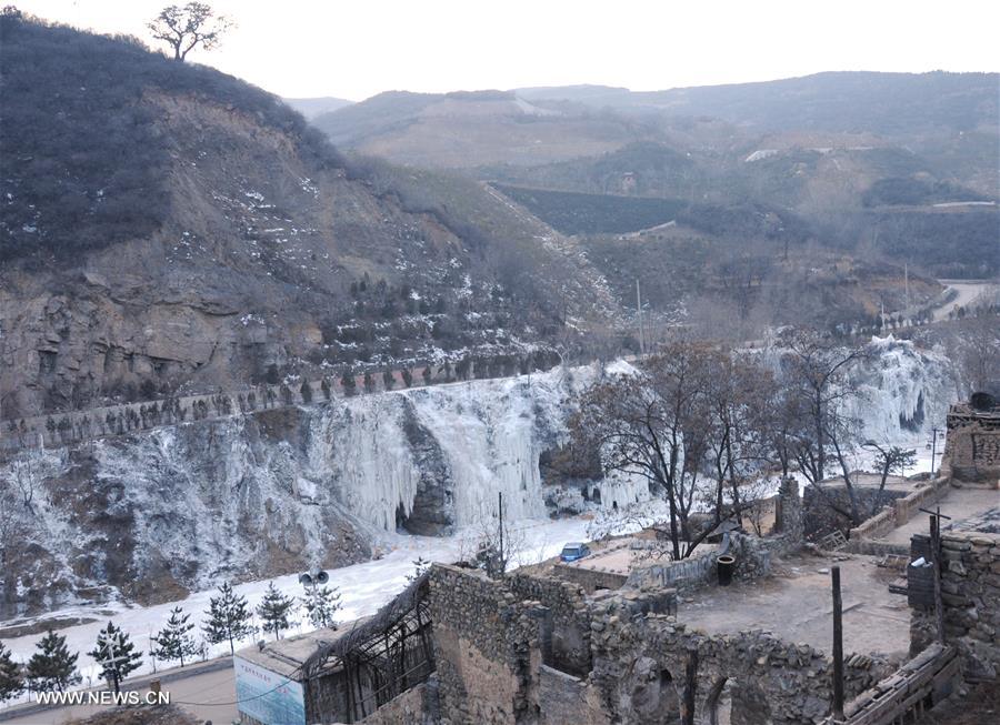 People take photos of frozen waterfalls in N China