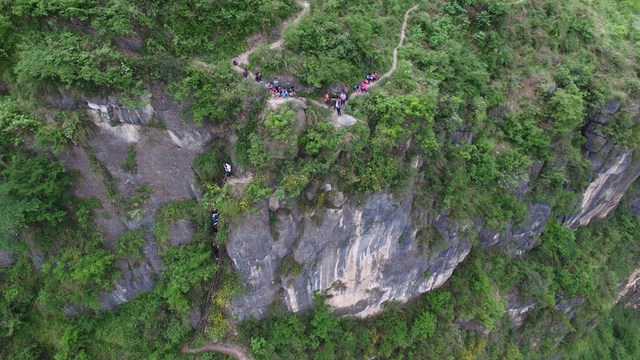 Children scale 800-meter cliff on way to school
