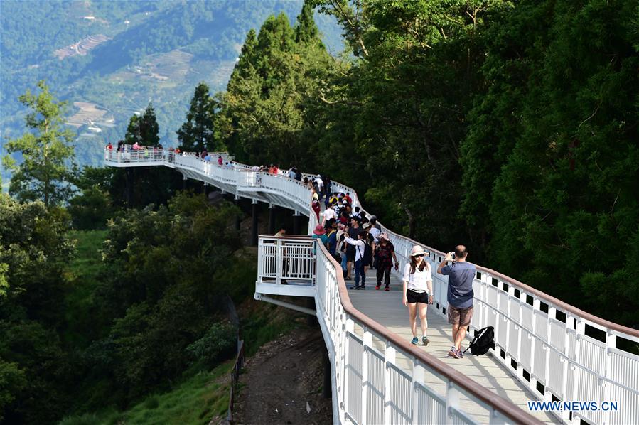 People enjoy scenery at high altitude sight-seeing footpath in Taiwan