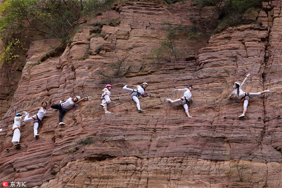 High on mountain: Yoga enthusiasts practice on cliff