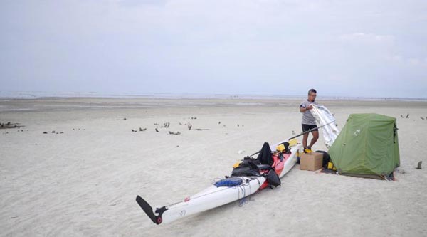 Man kayaks along China's coastline