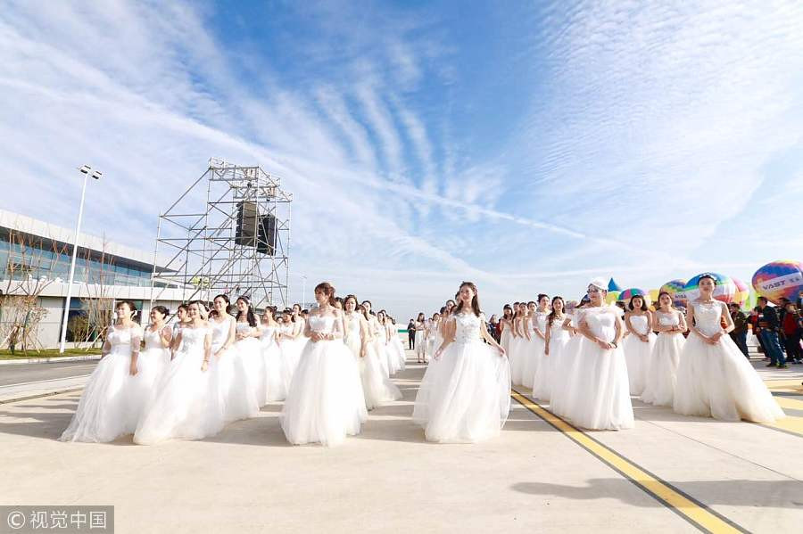 100 couples exchange vows in the air