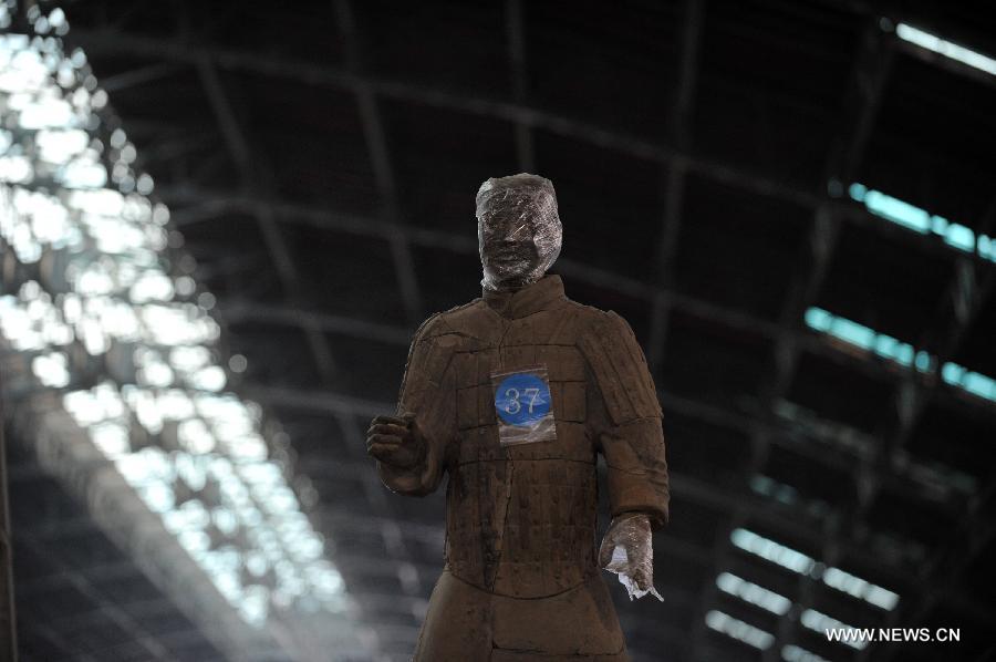 Terracotta warriors wrapped in cling film for protection of remnant painting