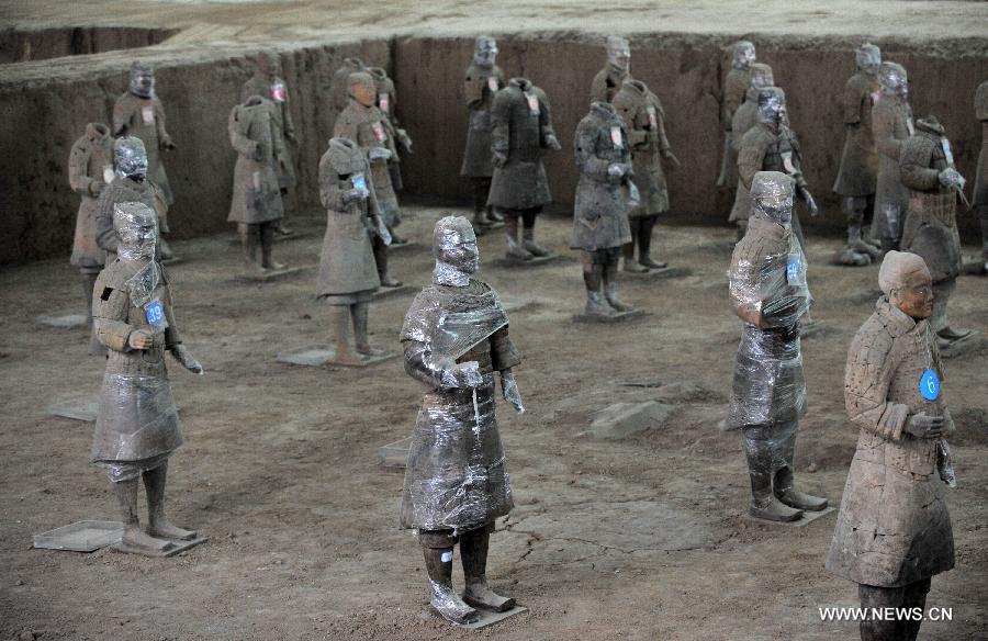 Terracotta warriors wrapped in cling film for protection of remnant painting