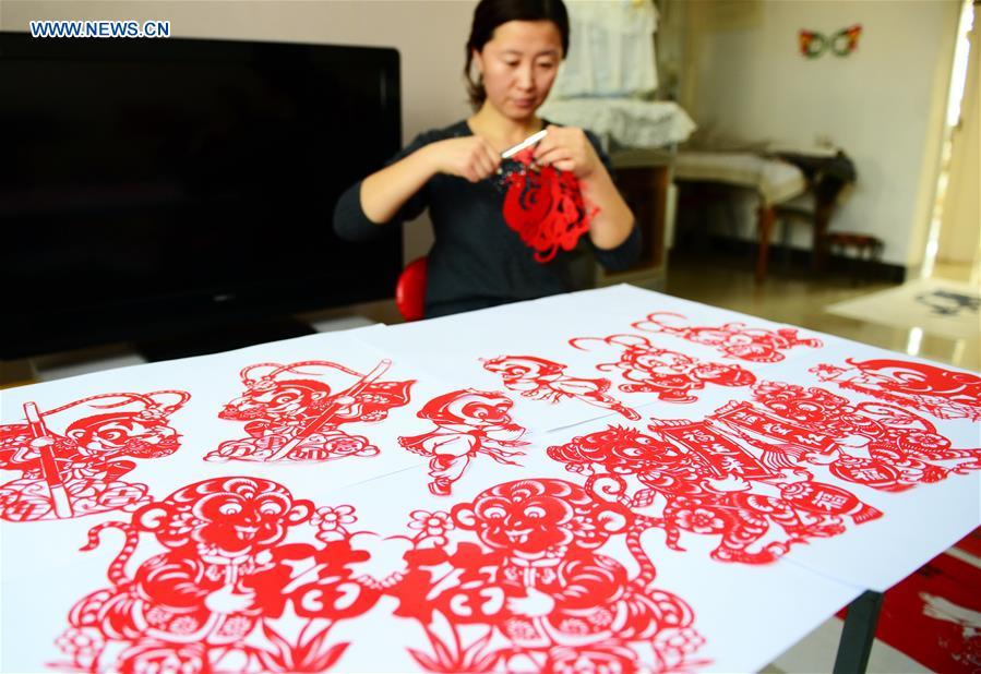 Folk paper-cutting artist shows her creations for Year of the Monkey