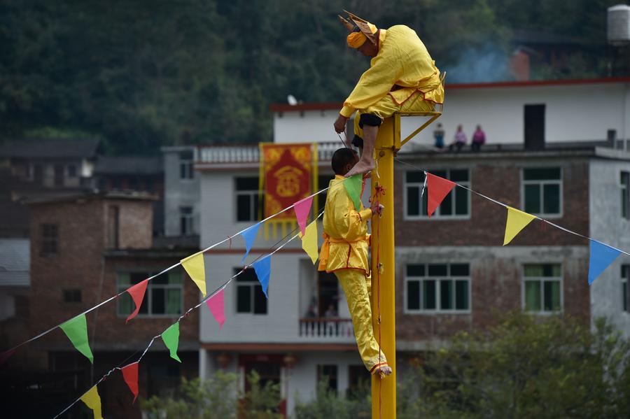 Stunt 'climbing on blades' performs in China's Fujian province