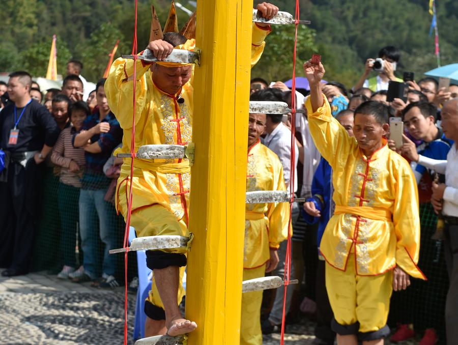Stunt 'climbing on blades' performs in China's Fujian province