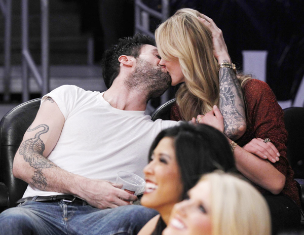Levine nuzzles with Russian model