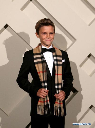 Like father like son: Romeo Beckham attends Burberry campaign