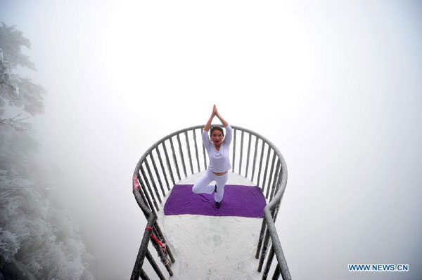 Women do yoga after snowfall