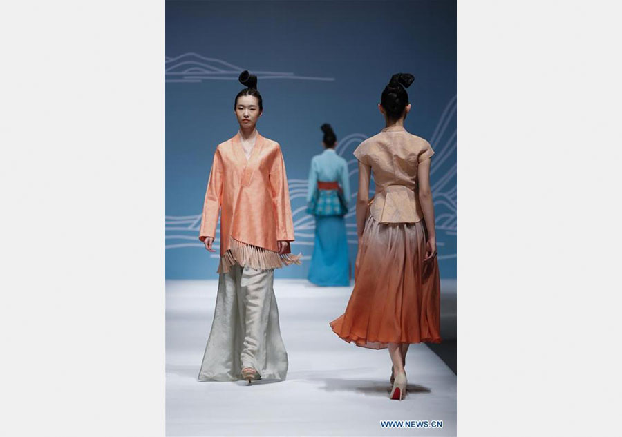 Models present creations designed by Dr. Chu Yan