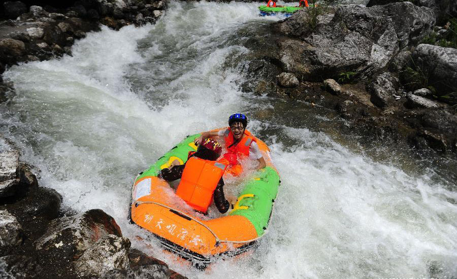 Tourists drift by rafts at China's Chaotianhou scenery spot
