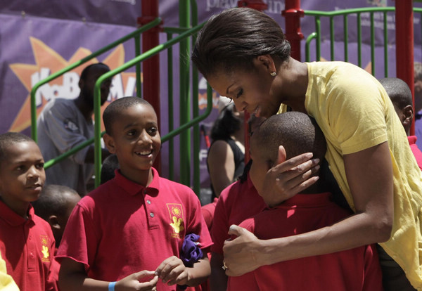US first lady joins volunteers to build playground
