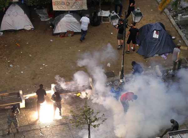 Greece passes steep cuts as riots seize capital