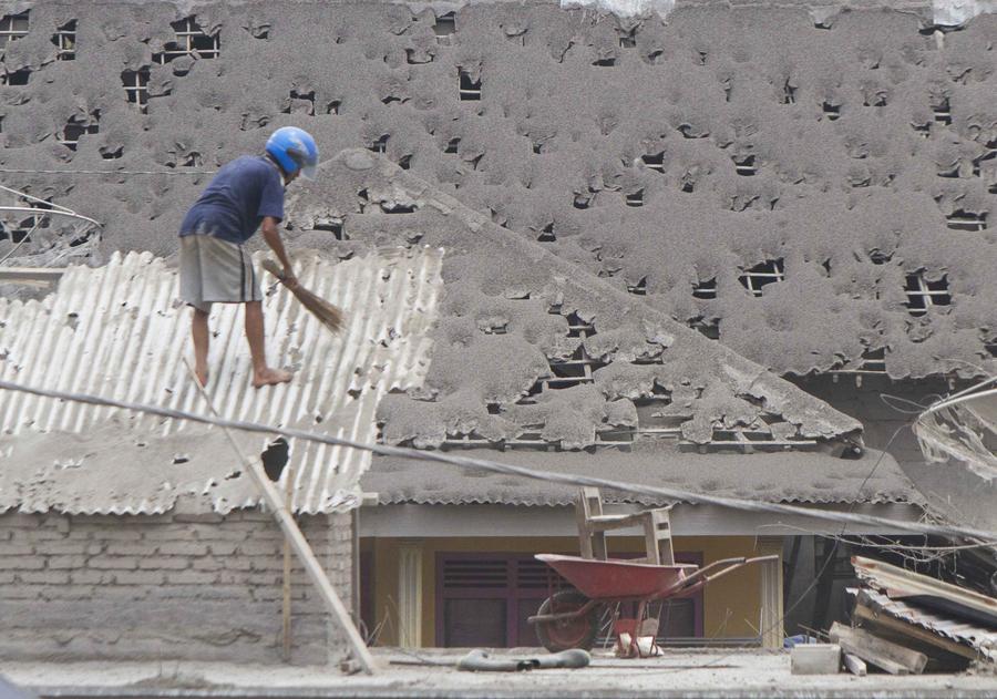 People clear volcanic ash in Indonesia