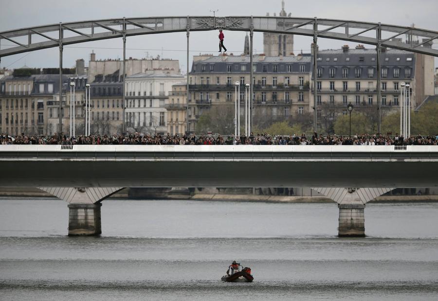 Tightrope walker completes walk over Seine river in Paris