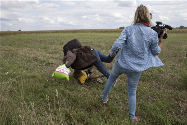 Hungarian TV journalist fired for tripping up fleeing migrants