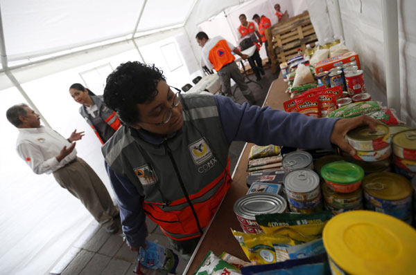 Ecuador counts over 400 quake deaths, damage in the billions