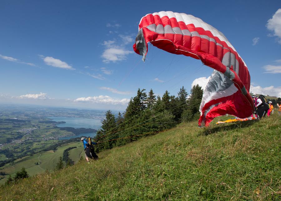 Paragliding fans fly over Rigi mountain in Switzerland