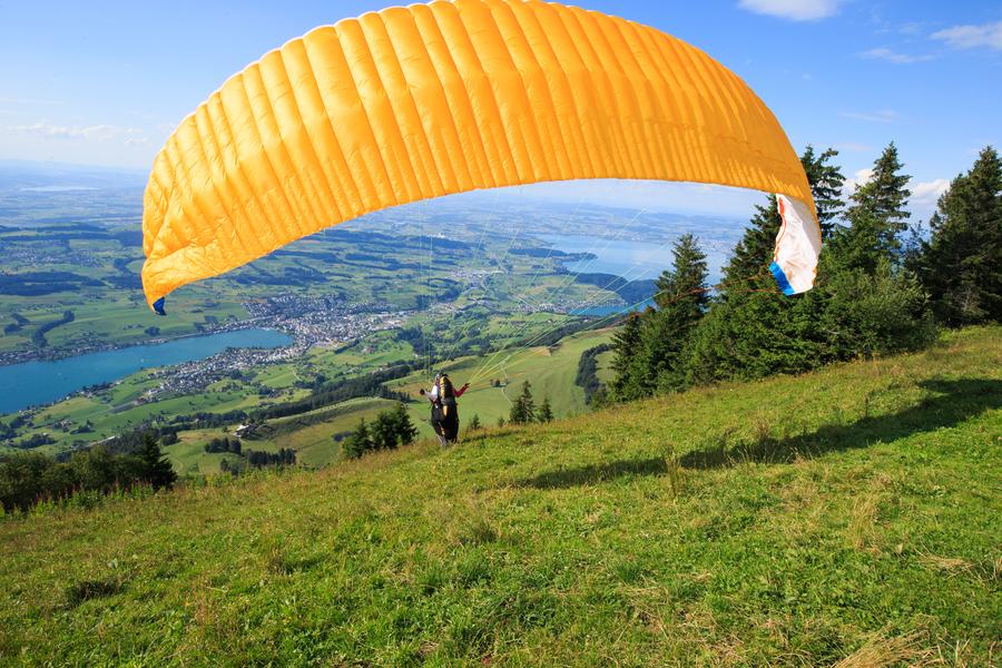 Paragliding fans fly over Rigi mountain in Switzerland
